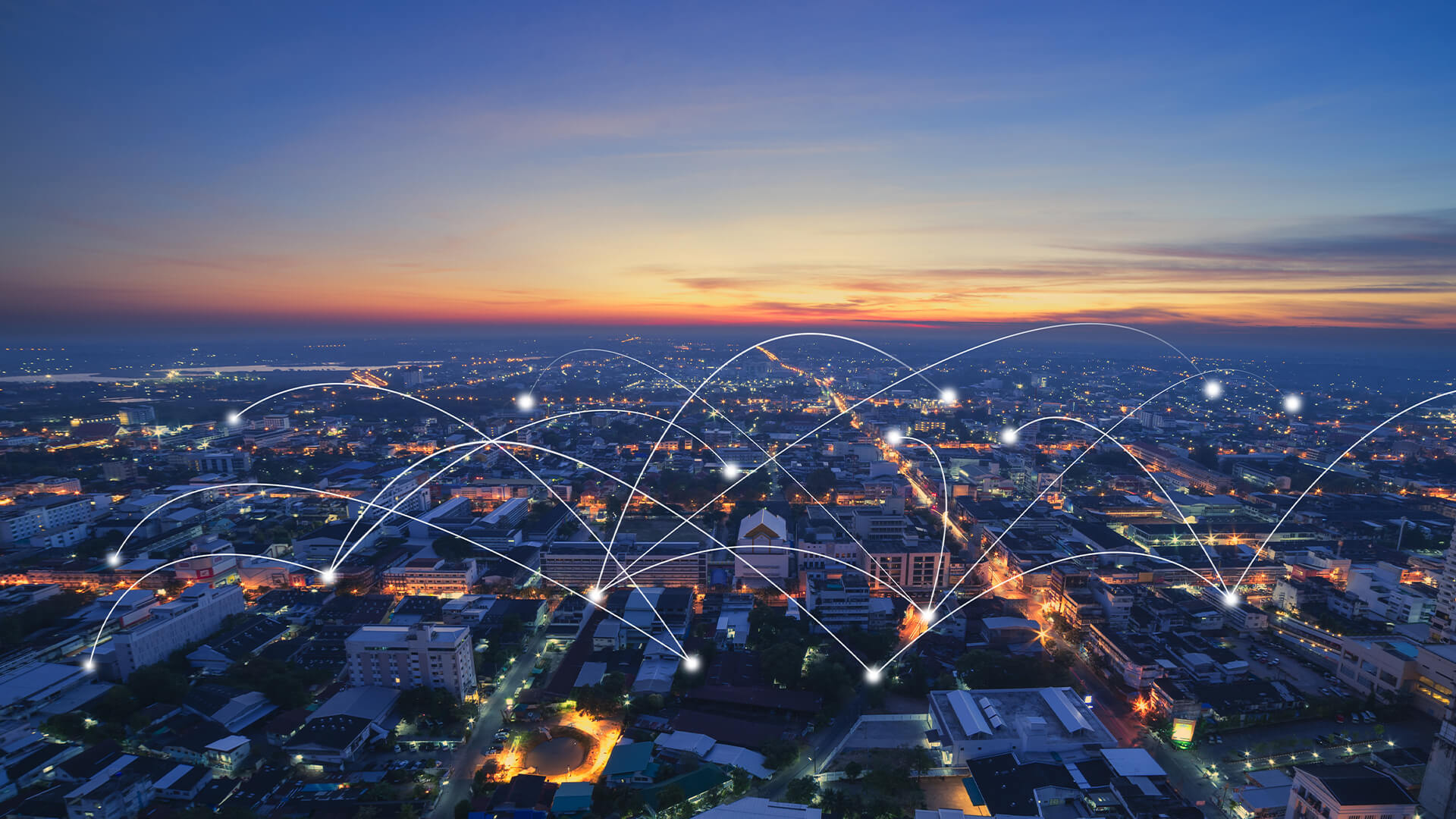 City skyline at sunset with lines connecting the buildings