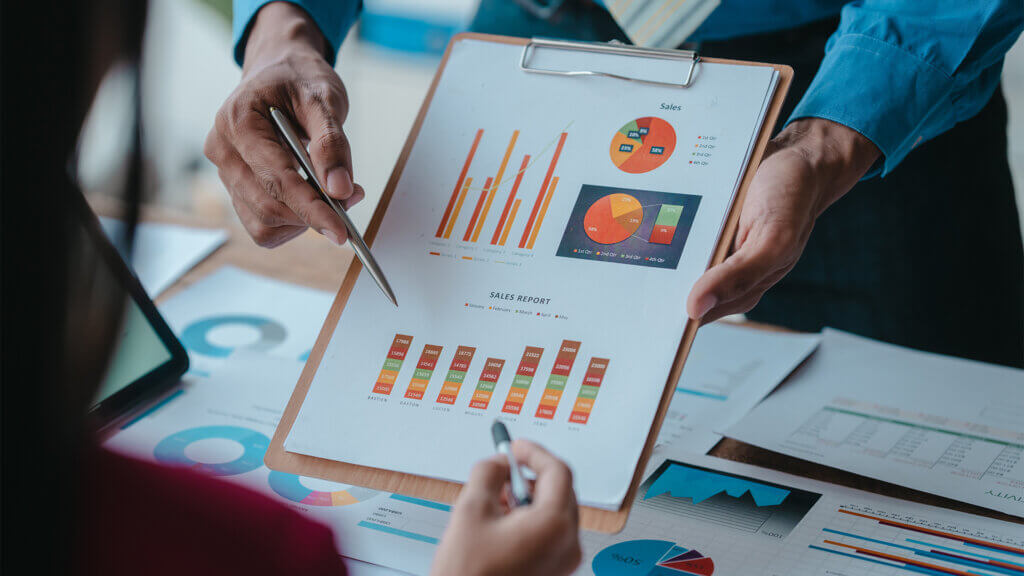 Close up bookkeepers working with balance sheet to analyze problems and find solutions to bringing develop business organization and company's stock market system