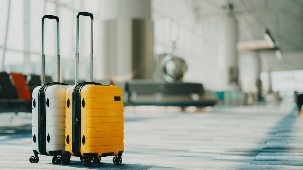 Two suitcases in an empty airport hall