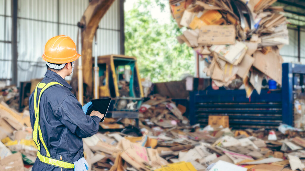 Engineer Standing to work with tablet Machines in the recycling industry