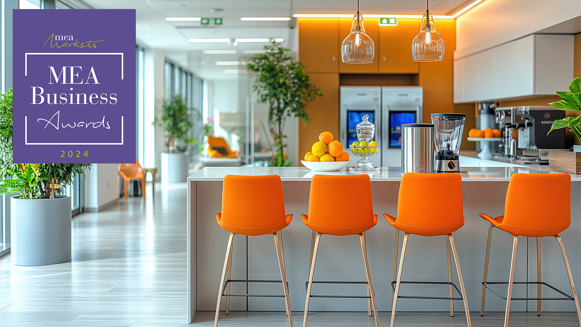 Modern office kitchen offering relaxing break area with orange chairs